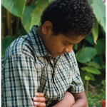 We can avoid sin more easily if we talk often to God. Boy praying.